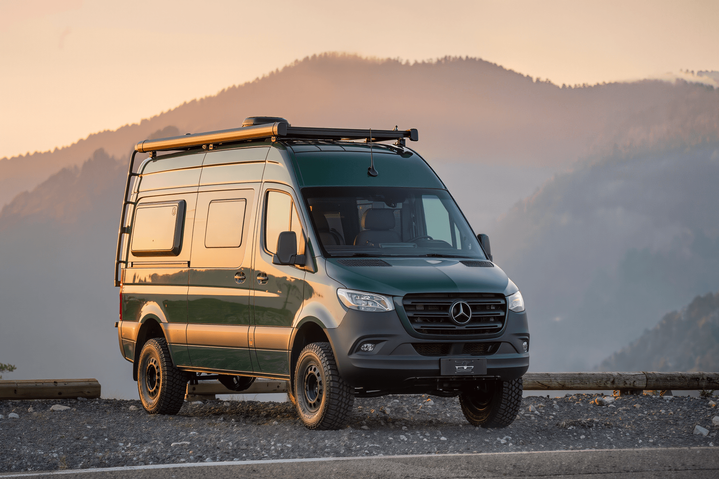 Forest green Mercedes Sprinter 170 4x4 camper van at a mountain overlook